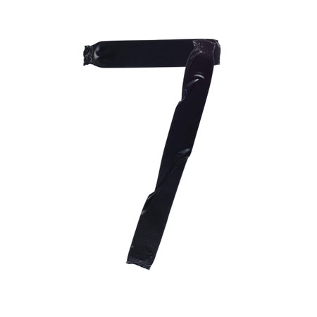 The number seven, 7 is made with pieces of black electrical tape on a white background, close-up,...