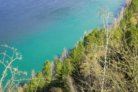 Beautiful forest river bank with emerald water, birds eye view.