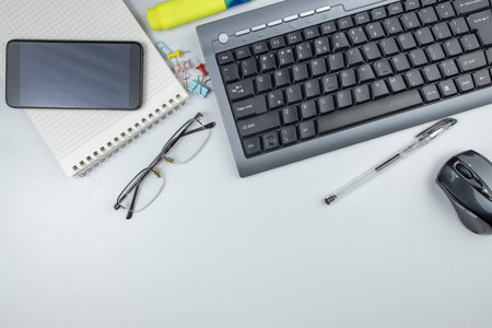 Workplace in the office computer keyboard and stationery, top view, copy space.