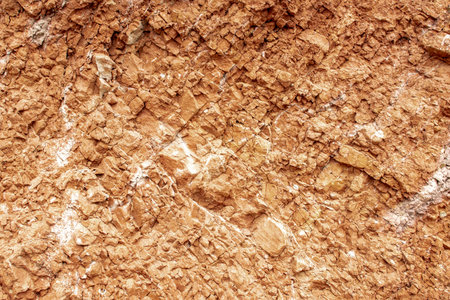 Texture of natural clay with cracks and pieces close-up
