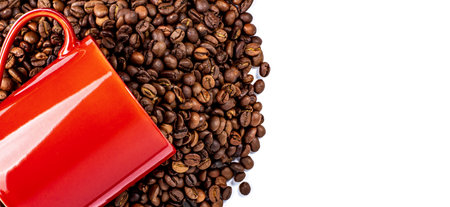 Mug with coffee beans on white isolated, top view of coffee beans and space for text, copy space