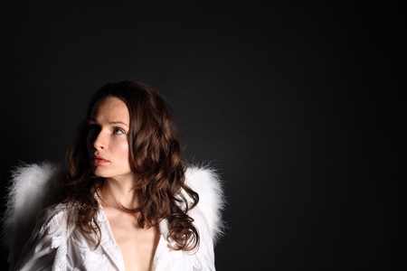 Young woman with angel wings - low keyの写真素材