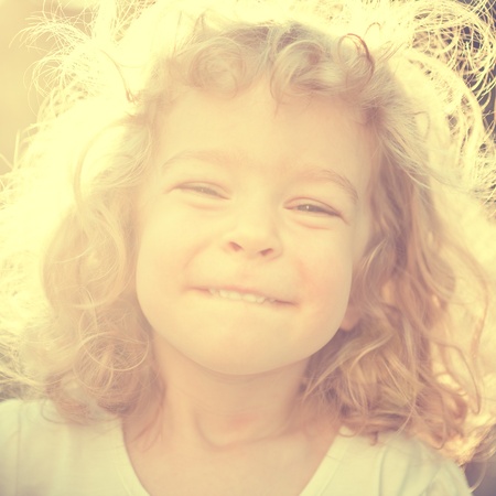 Smiling child in sunny hazeの写真素材