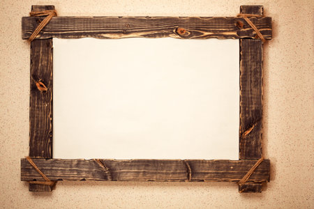 Vintage wooden frame with canvas suspended on wall. Art background