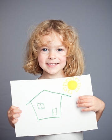 Drawn sun and house in baby hands. Spring conceptの写真素材