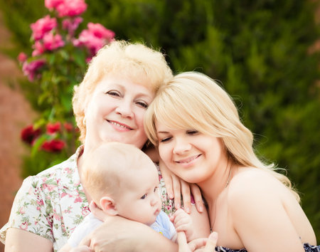 Portrait of happy family outdoors in summer garden