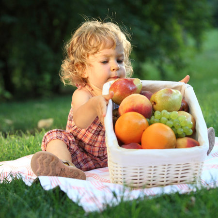 Child having picnic in summer park. Shallow depth of fieldの写真素材