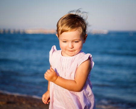 Funny child running at the beachの写真素材
