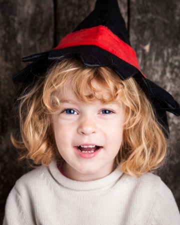 Happy laughing kid in hat of witch. Halloween conceptの写真素材
