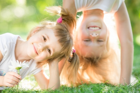 Happy children playing outdoors in spring parkの写真素材