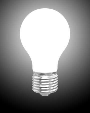 Glowing light bulb on dark backgroundの写真素材
