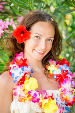 Happy smiling woman with flower lei garland of orchids. Summer vacations conceptの写真素材
