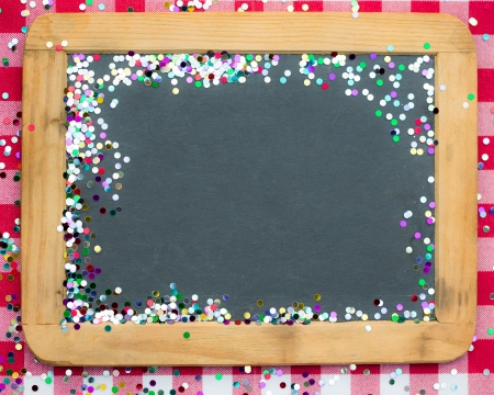Christmas frame of confetti on blackboard blank  Winter holidays conceptの写真素材
