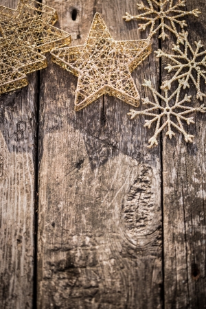 Gold Christmas tree decorations on grunge wood background  Winter holidays concept  Copy space for your text  Shallow depth of fieldsの写真素材