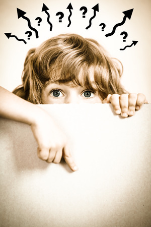 Child looking from behind the paper blank. Creative conceptの写真素材