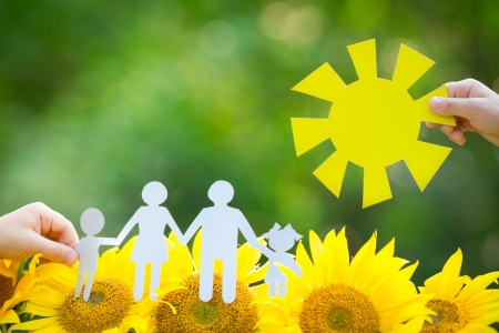 Children holding paper family and sun outdoorsの写真素材