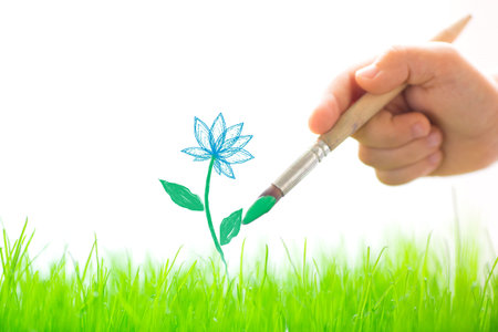 Drawing flower over spring green grassの写真素材