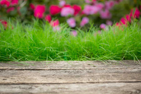 Wooden table against green grassの写真素材