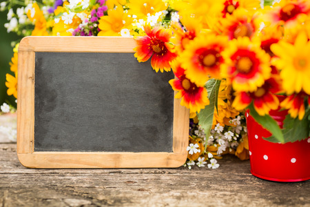 Spring flowers and blackboard with copy spaceの写真素材