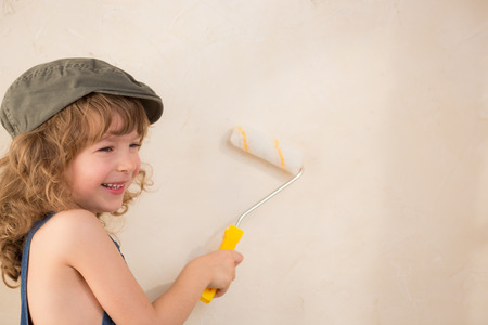 Kid painting wall. Renovation conceptの写真素材