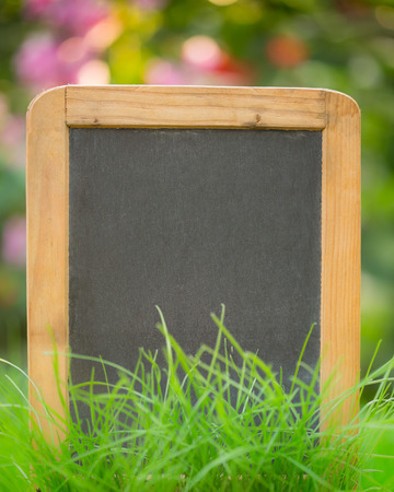 Wooden blackboard on green grassの写真素材