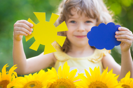 Happy child playing outdoors in spring parkの写真素材