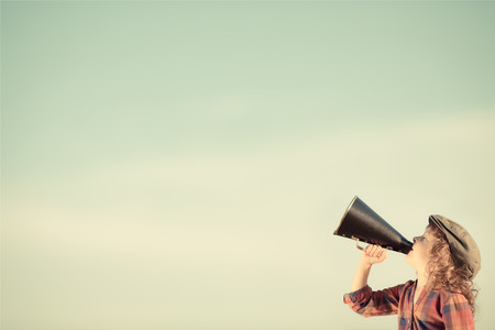 Kid shouting through vintage megaphone. Communication concept. Retro styleの素材 [FY31026772817]