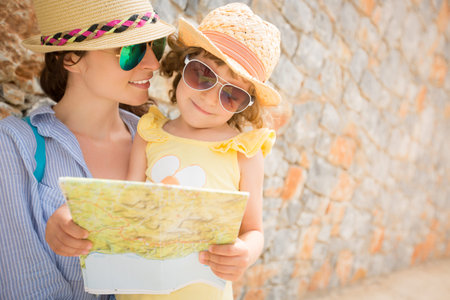 Hipster woman and girl in summer city. Travel and vacations concept
