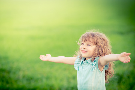 Happy child relaxing outdoors in spring filedの写真素材