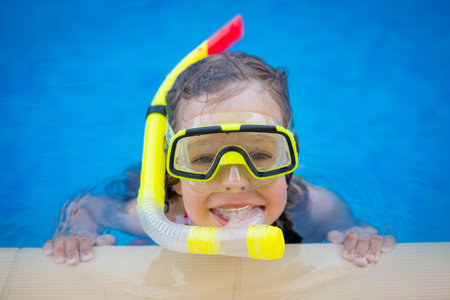 Happy child playing in swimming pool. Summer vacation conceptの写真素材
