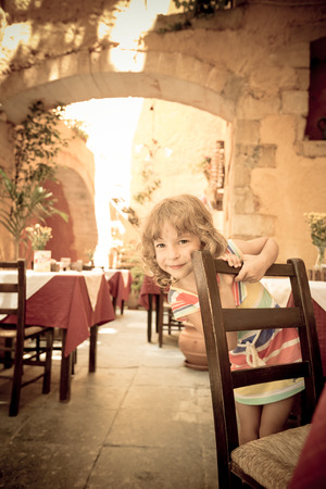 Child having fun in summer cafe outdoorsの写真素材