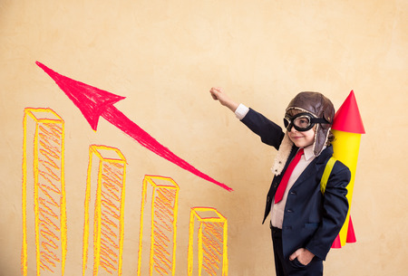 Portrait of young businessman with paper rocket. Success, creative and startup concept. Copy space for your text