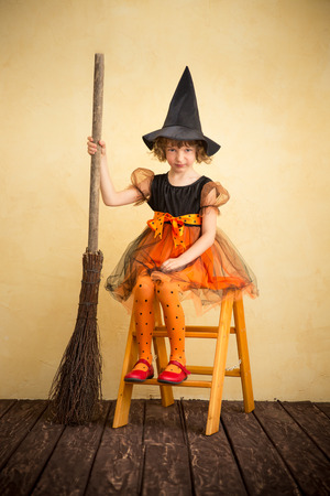 Funny child dressed witch costume. Halloween holidays conceptの写真素材