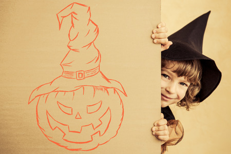 Funny child dressed witch costume. Halloween holidays conceptの写真素材