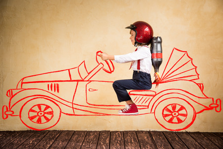 Portrait of young businessman with jet pack riding drawing retro car. Success, creative and innovation technology concept. Copy space for your textの写真素材