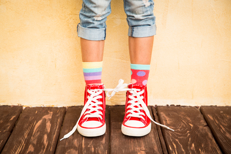Red sneakers on children legsの写真素材
