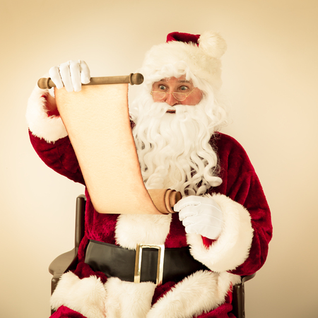 Santa Claus reading scroll. Christmas holiday conceptの写真素材