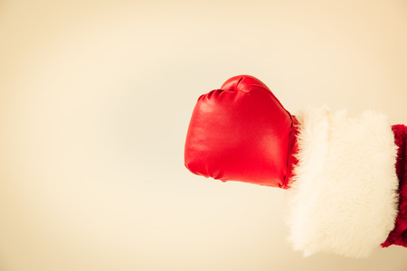 Santa Claus hand wearing boxing glove. Christmas holiday conceptの写真素材