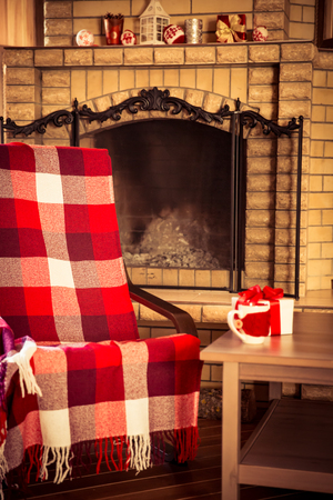 Armchair near fireplace. Winter holiday conceptの写真素材