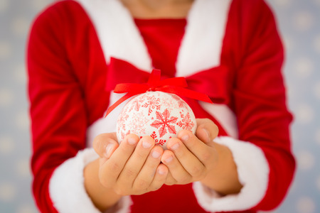Child holding Christmas ball. Xmas holiday conceptの写真素材