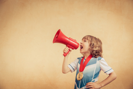 Child is pretending to be a soccer player. Success and winner conceptの写真素材