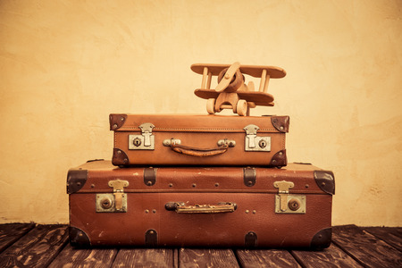 Vintage toy airplane and suitcase. Summer vacation and travel conceptの写真素材