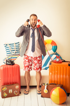 Funny businessman ready for a summer vacation. Man having fun at homeの写真素材