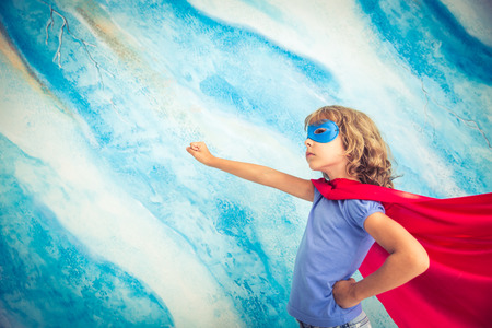 Superhero child. Kid super hero. Freedom, winner and success concept. Dream and imaginationの写真素材