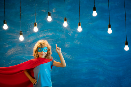 Superhero child. Kid super hero. Freedom, winner and success concept. Dream and imaginationの写真素材