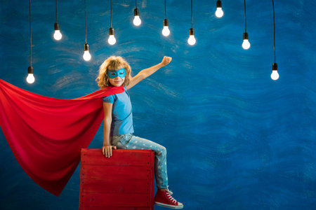 Superhero child. Kid super hero. Freedom, winner and success concept. Dream and imaginationの写真素材