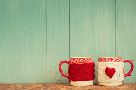 Pair of cups against emerald wooden background. Valentines day ornament. Greeting cardの写真素材