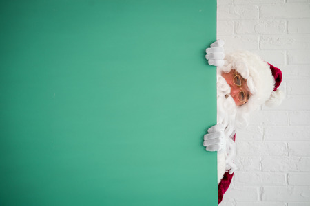 Santa Claus holding banner blank. Merry Christmas greeting card. Xmas holiday conceptの写真素材