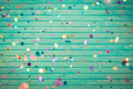 Happy New Year! Confetti falling on wooden backgroundの写真素材