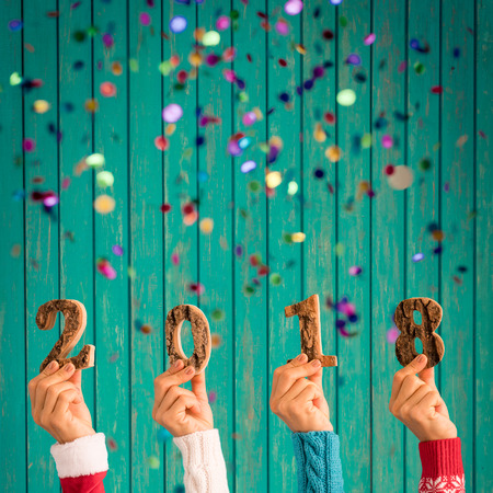 Happy New Year 2018! Confetti falling against wooden backgroundの写真素材